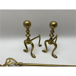 Set of three brass long-handled fire tools, the tongs with Art Nouveau mounts; and a pair of brass fire-dogs with spherical terminals (5)