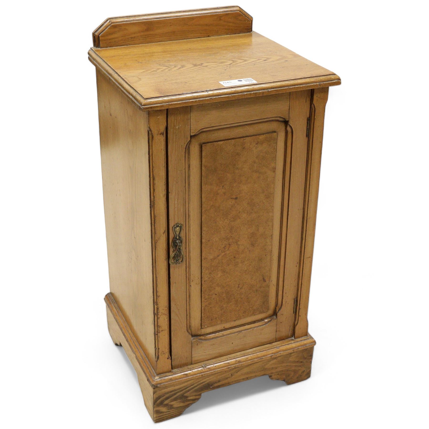 Late Victorian ash and walnut bedside pot cupboard, raised canted back over square moulded top, enclosed by single panelled door with figured walnut veneer, on bracket feet 