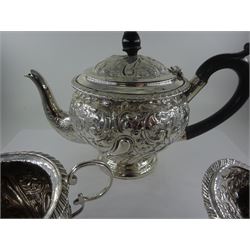 Late Victorian silver three piece bachelors tea service, comprising teapot, open sucrier and milk jug, each of bellied form, upon a circular stepped foot, and profusely embossed with foliate and scrolling decoration, the teapot with ebonised handle and finial, hallmarked George Nathan & Ridley Hayes, Birmingham 1894, teapot H14.5cm