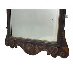 18th century black lacquered and gilt wall mirror, broken arch pediment with central cartouche decorated with curled leaves and foliate motifs, scrolled acanthus leaf eared brackets, bevelled mirror plate within gilt slip and moulded outer frame, lower shell motif surrounded by curled acanthus leaves and shield motifs 