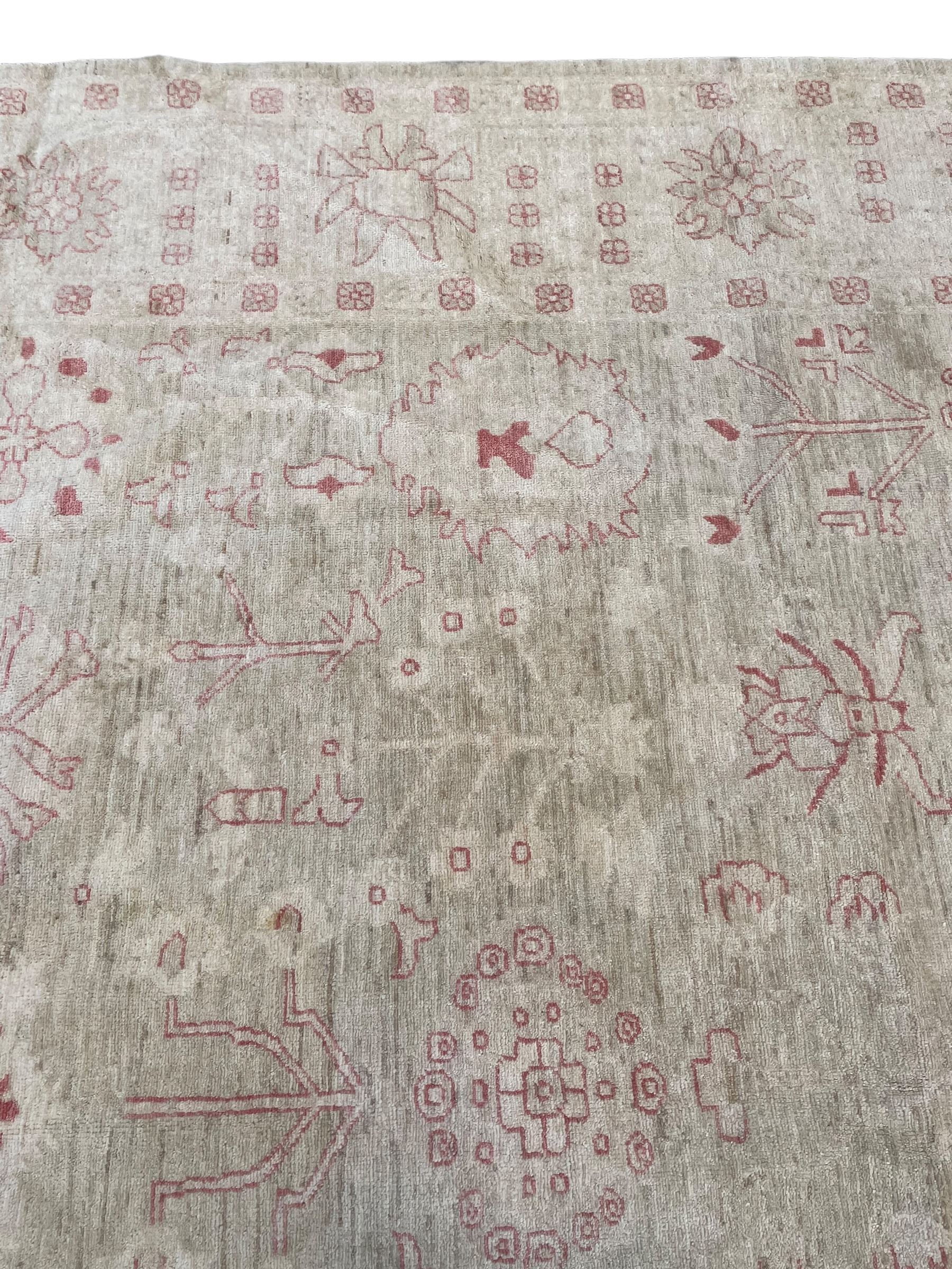 Persian design pale ivory ground carpet, decorated with stylised plant and leaf motifs in pale red