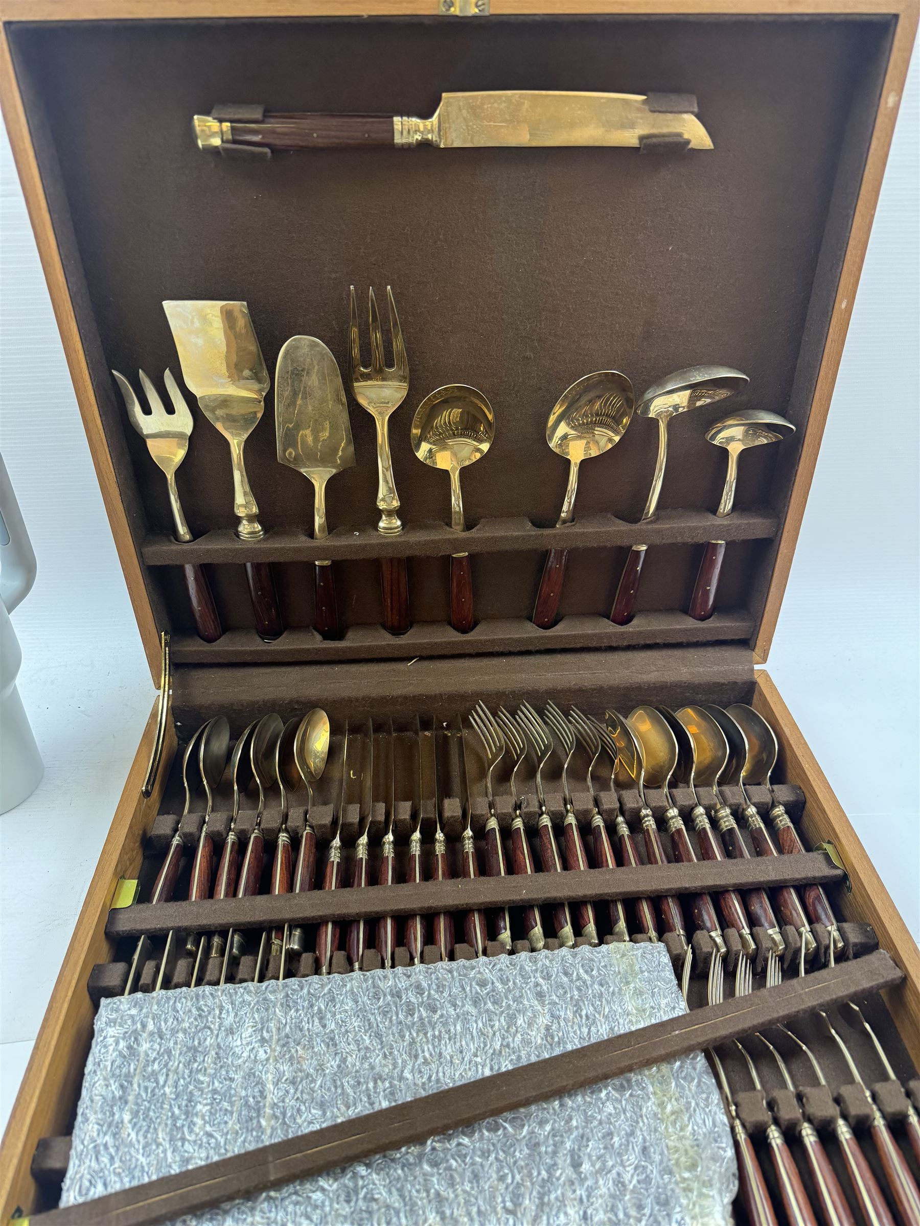 Wooden cased six place Thai gilt metal canteen of cutlery, together with additional matching flatware 