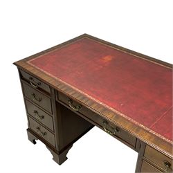 Georgian design mahogany twin pedestal desk, moulded rectangular top with red leather inset, fitted with seven drawers, on bracket feet 