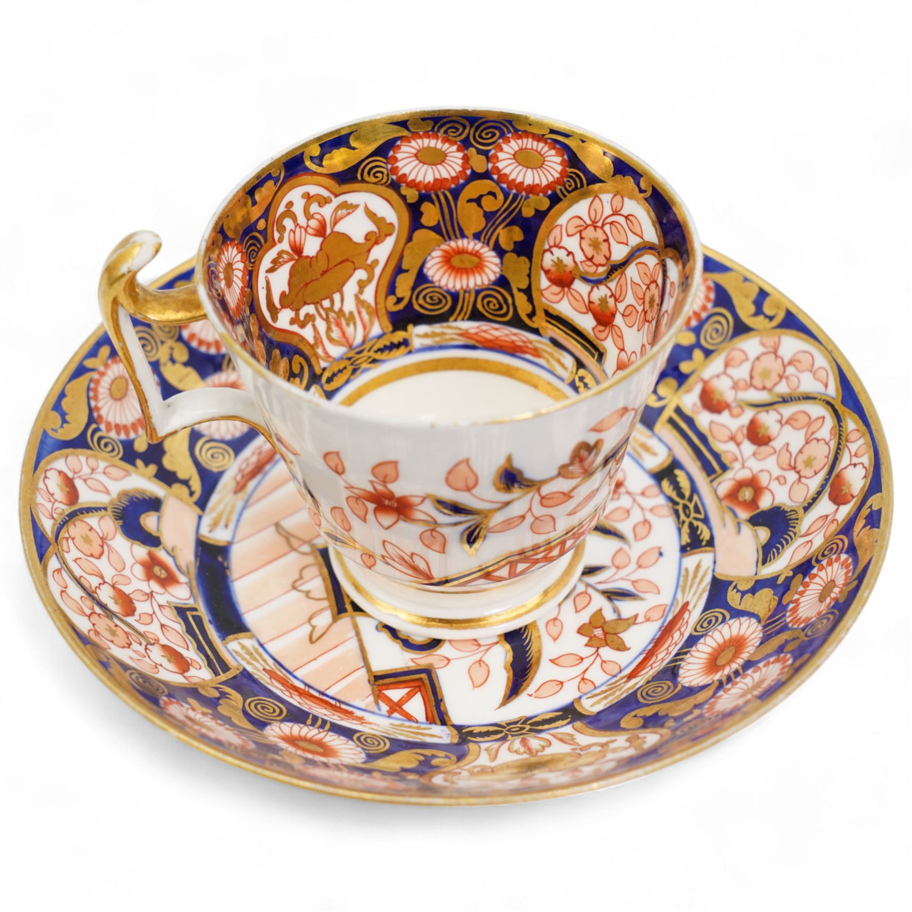 Four early 19th century Spode cups and saucers, two decorated in the Imari palette, pattern no. 2375, and two others, pattern no. 3260 & 1709, together with two early 19th century porcelain rococo revival chambersticks and another Spode tea cup (11)