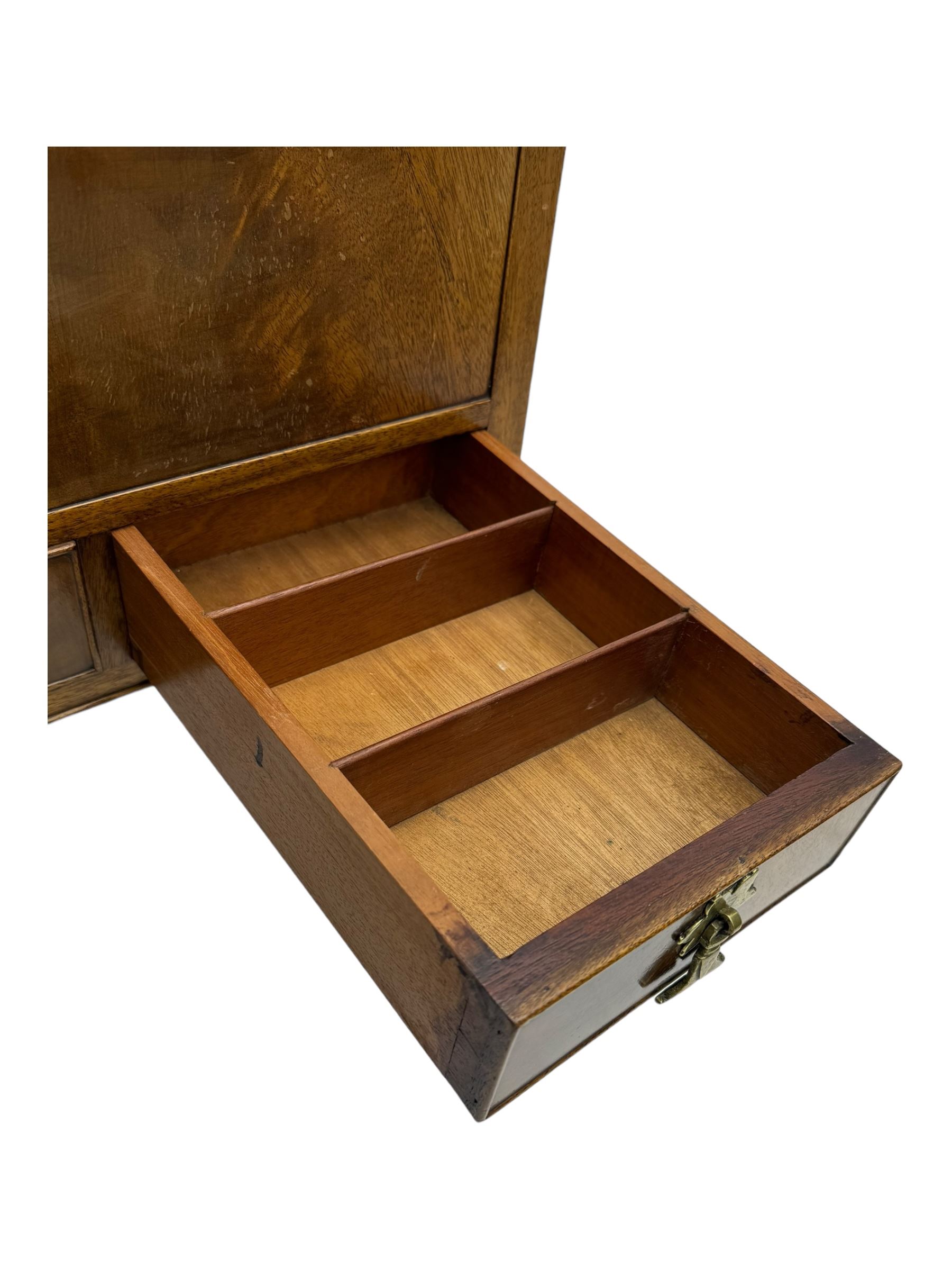 Early 20th century mahogany work table, hinged top enclosing satin-lined compartment with pincushion and pockets, lower section fitted with two drawers with dividers, on cabriole supports with carved knees and claw feet