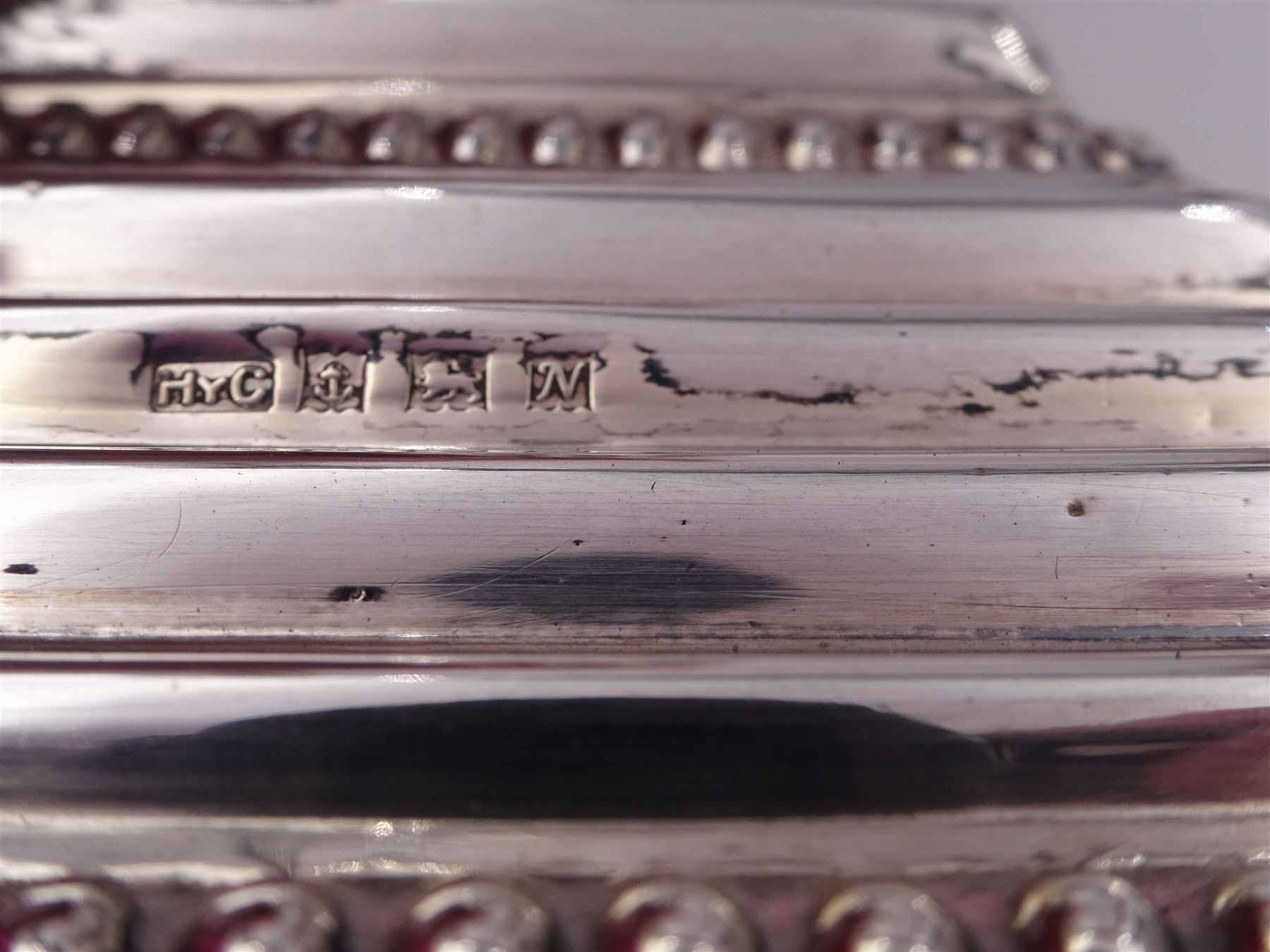 Pair of modern silver Corinthian column candlesticks, each with removable sconces with dart edging and embossed detailing, with personal engraving in a Semitic language, upon weighted stepped square bases, hallmarked Birmingham 1962, maker's marks HYC, H30.5cm