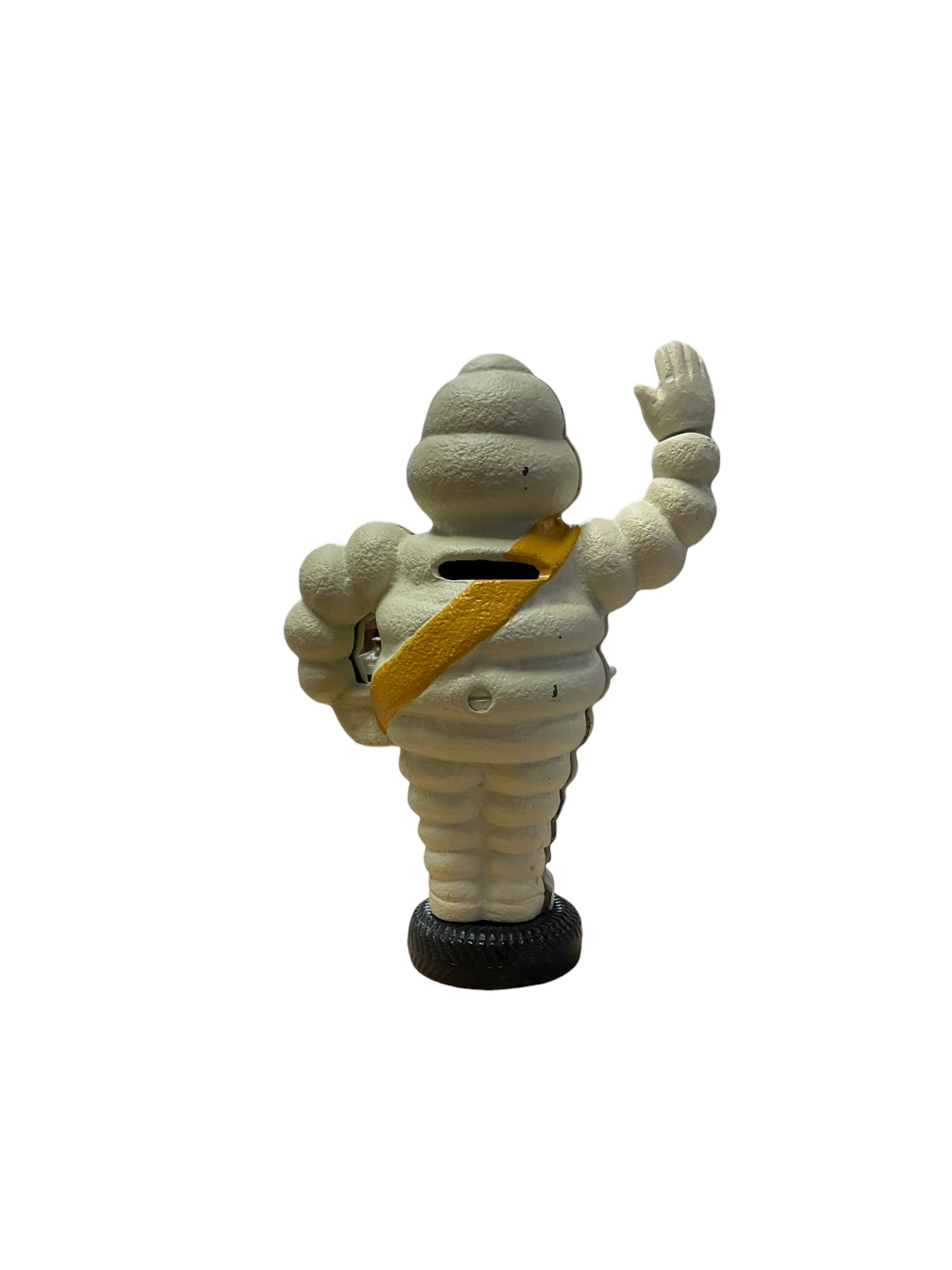 Cast iron money box figure of Michelin Man, stood on a tyre, H24cm