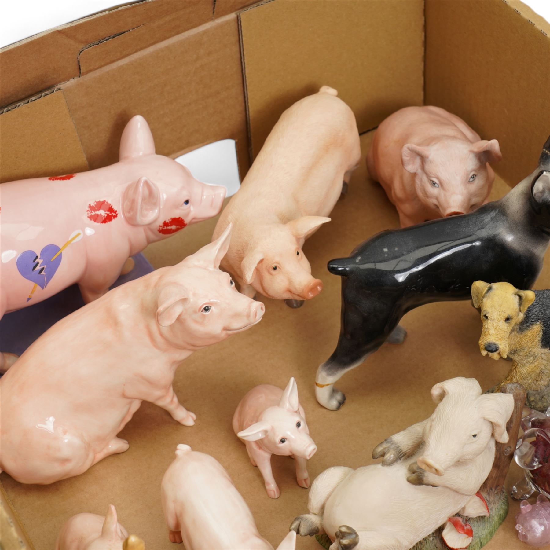 John Beswick family of four pigs, Beswick Airedale Terrier Cast Iron Monarch, together with other animal figures, in one box