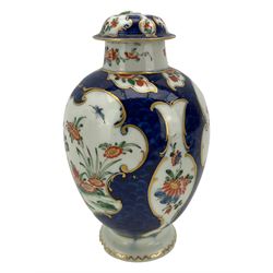 18th century Worcester tea caddy, of oval form and painted in the Kakiemon palette with reserves of flowers against a blue scale ground, H14cm together with a similar Worcester circular dish, painted with floral sprays, within a scalloped edge, blue crescent mark beneath, D19cm (2)