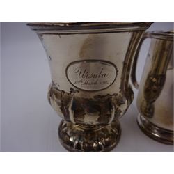 Two silver christening mugs, the first a Victorian example, of part fluted waisted form, upon circular foot with scroll handle, hallmarked Edward, John & William Barnard, London 1838, the second example of plain slightly tapering form with C handle, hallmarked S Blanckensee & Son Ltd, Chester 1929, tallest H9cm