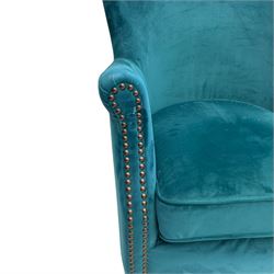 Contemporary tub-shaped armchair, upholstered in teal blue fabric, with high back and rolled arms accented with brass studded trim, on square tapered front feet