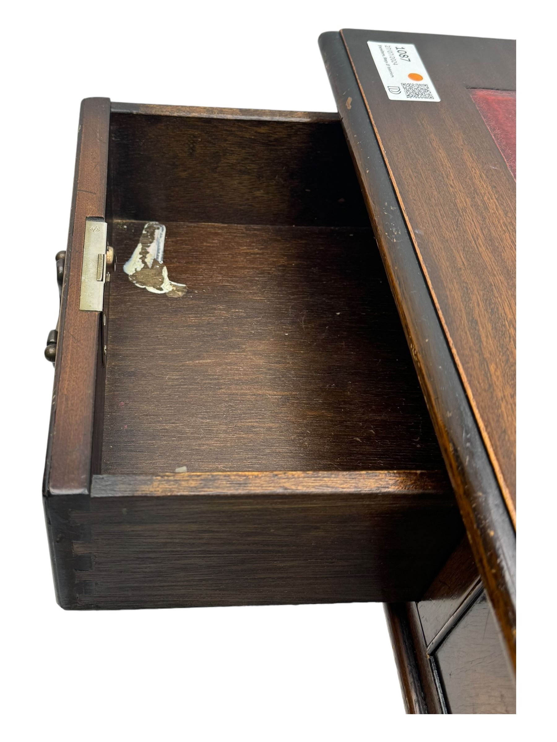 20th century mahogany twin pedestal desk, moulded rectangular top with red leather inset with gilt tooled border, central drawer over kneehole flanked by two banks of four graduating cockbeaded drawers, on plinth base