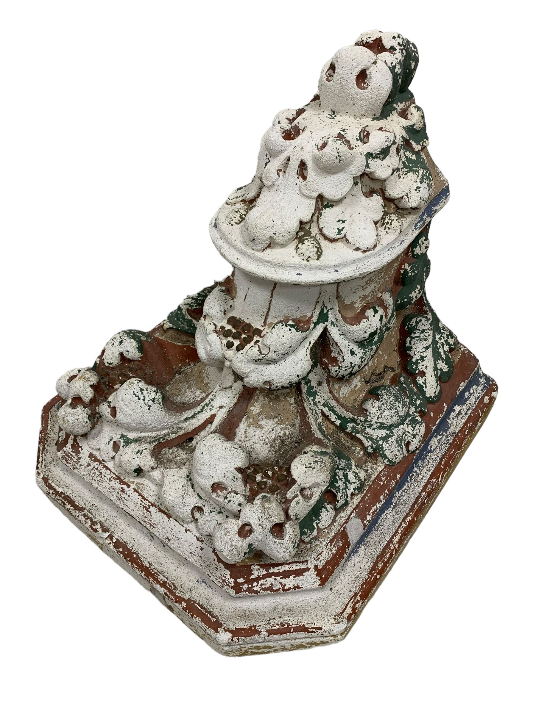 Two Victorian polychromed plaster cast corbels or wall brackets, canted rectangular tops over moulded edge and curled fruiting foliage