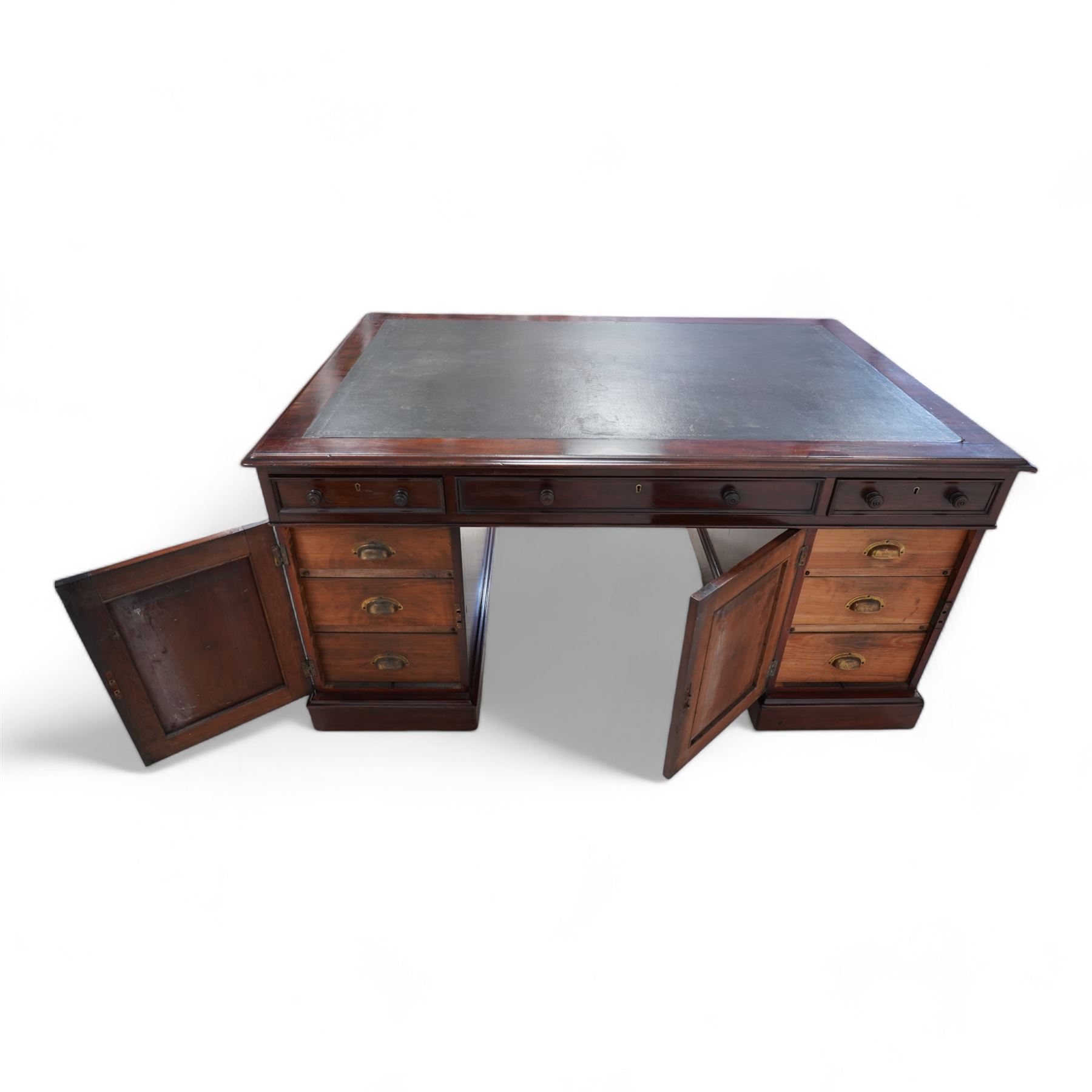 Victorian mahogany twin pedestal desk, moulded rectangular top with leather inset, one side fitted with nine drawers, the opposing side fitted with three drawers and two cupboards, two panelled doors enclosing further drawers, on moulded plinth base 