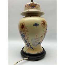 Oriental style table lamp modelled as a ginger jar, with foliate decoration in blue and red, including fixtures H43.5cm.