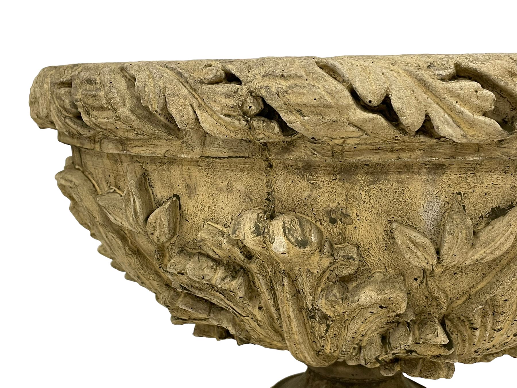 Pair of composite stone garden urn planters, acanthus leaf garland rim over foliate decorated body, stepped foot on square base