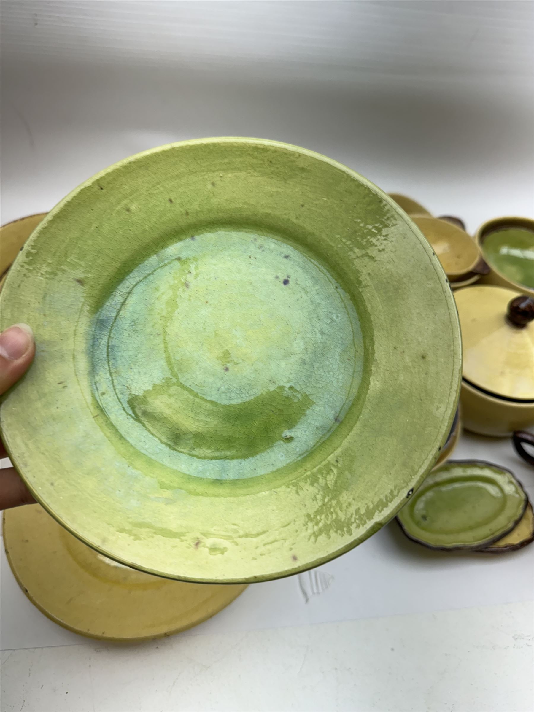 French green and yellow glazed tea and dinner wares by Etienne Noel, including milk jugs, teacups, side plates, bowls etc (43)