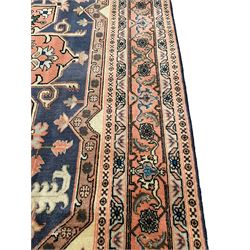 Persian ivory and peach ground, overall geometric design, the field with central star medallion surround stylised leaf motifs, guarded geometric design border