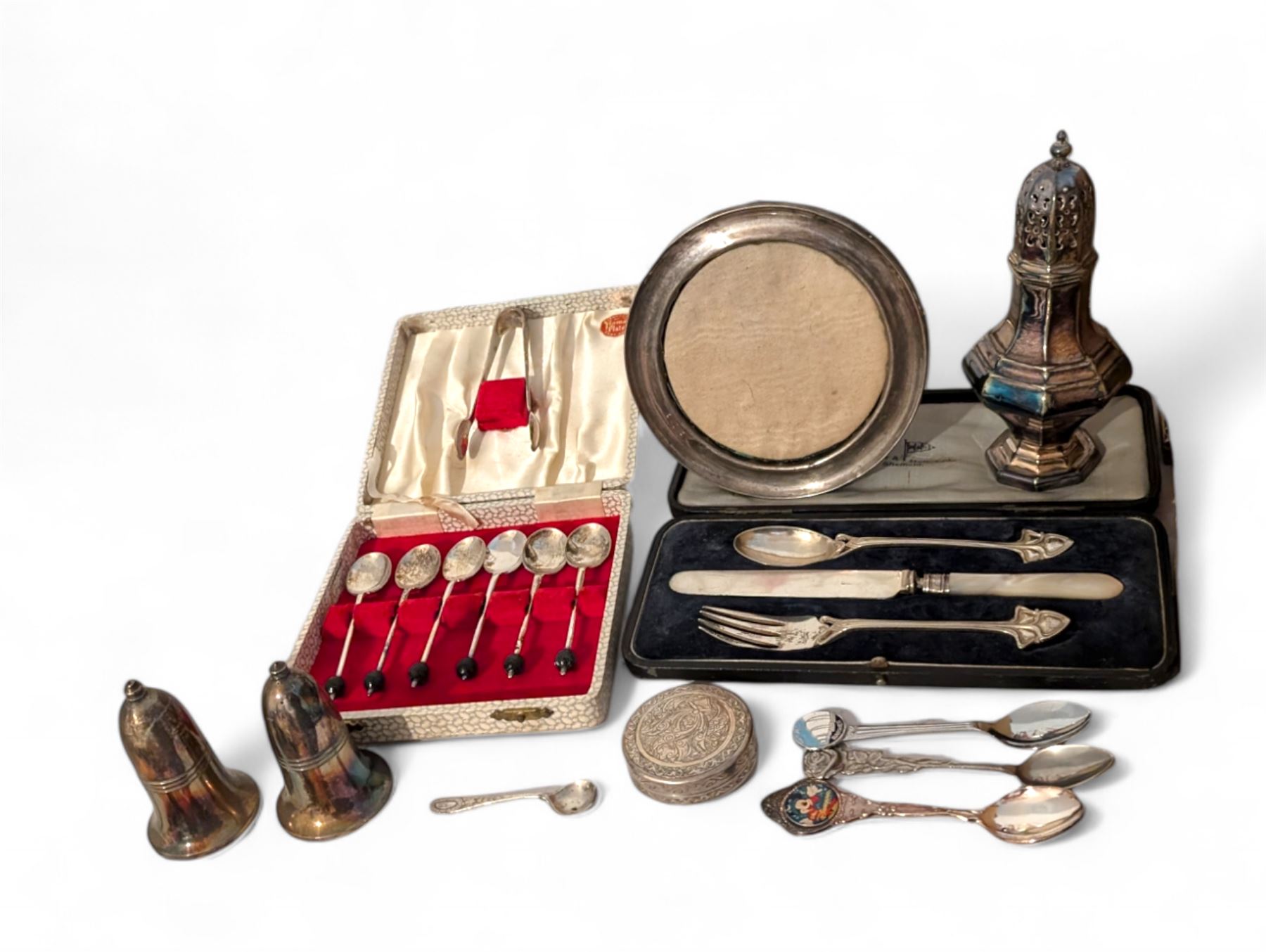 Silver photograph frame and a silver mustard spoon, both hallmarked, together with an Egyptian silver box, silver plated Walker & Hall christening set, silver plated sugar caster, silver plated coffee bean spoons, and silver plated pepper and salt shaker