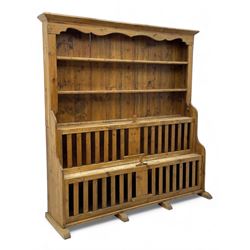 Waxed pine 'chicken coop' or 'hutch' dresser, projecting cornice over shaped frieze and three tier plate rack, the stepped waterfall lower section fitted with two slatted chicken coops, on sledge feet 