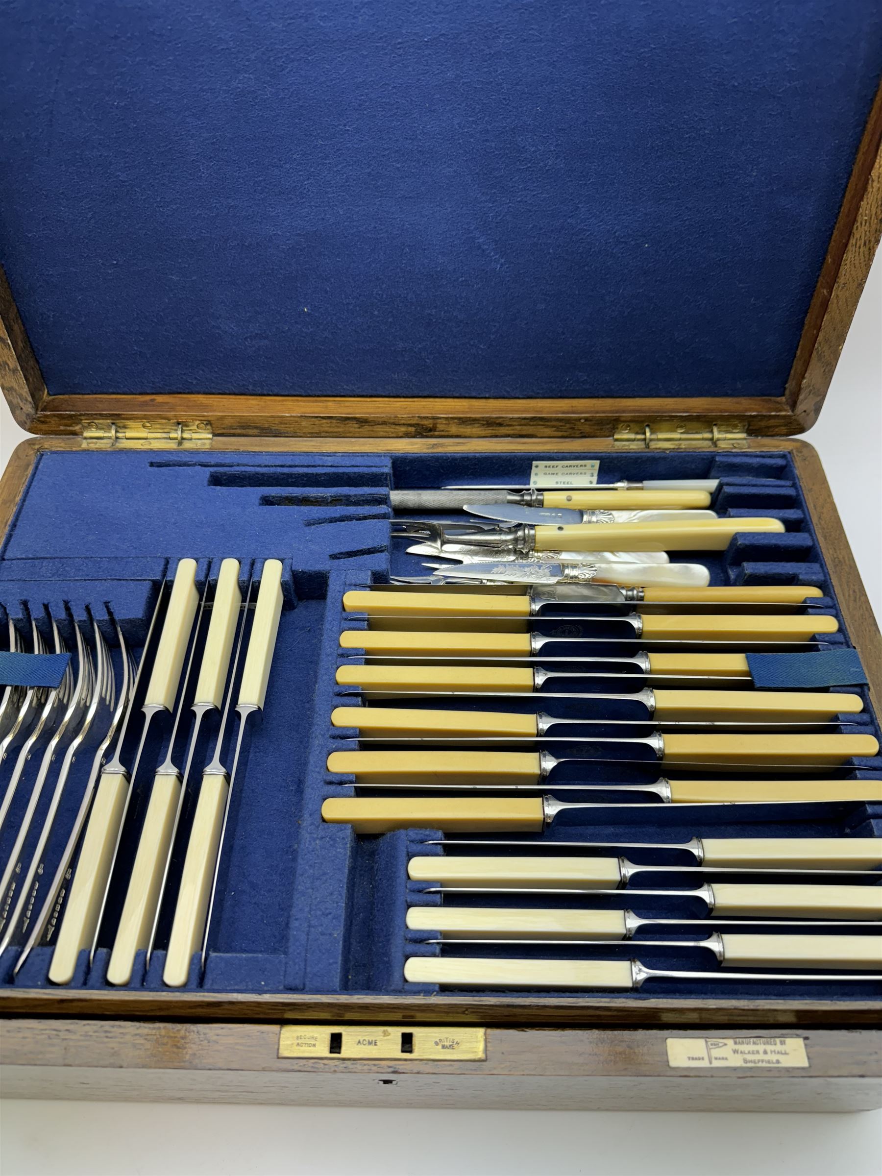 Walker & Hall canteen of plated cutlery for for twelve place settings, all knives with ivory effect handles, within an oak canteen case with a brass shield to the lid, with key, case  