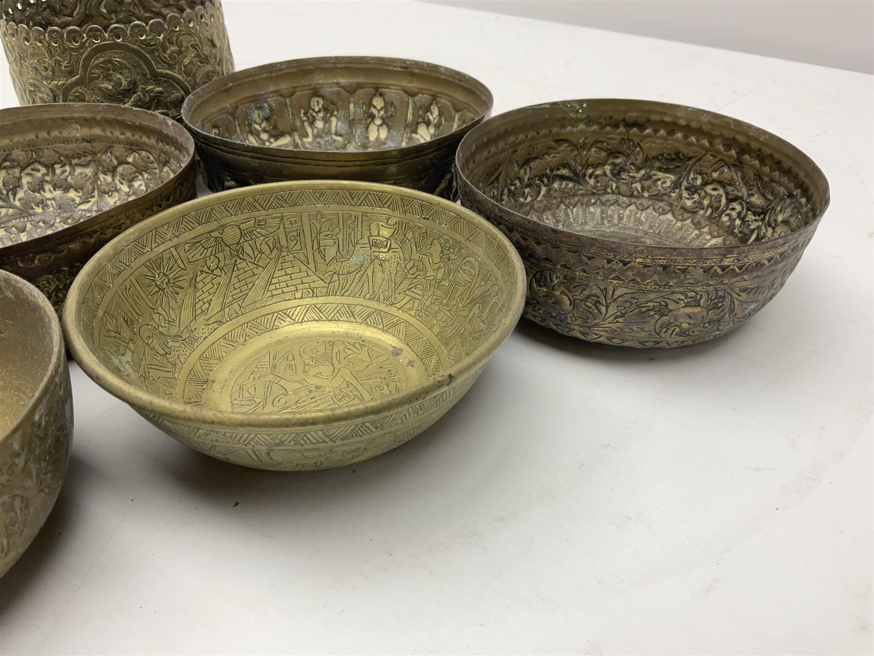 Beaten copper tray with repeat pattern and fluted rim, together with six brass cups, tray L41cm 