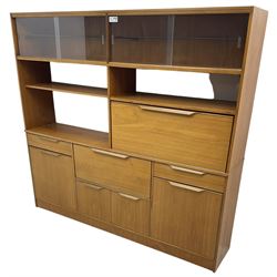 Mid-20th century teak sectional wall unit, combination of cupboards and drawers, raised sliding glass doors