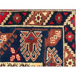 Turkish crimson ground rug, the field decorated with three geometric medallions within a band of star motifs, the main border decorated with stylised plant motifs 