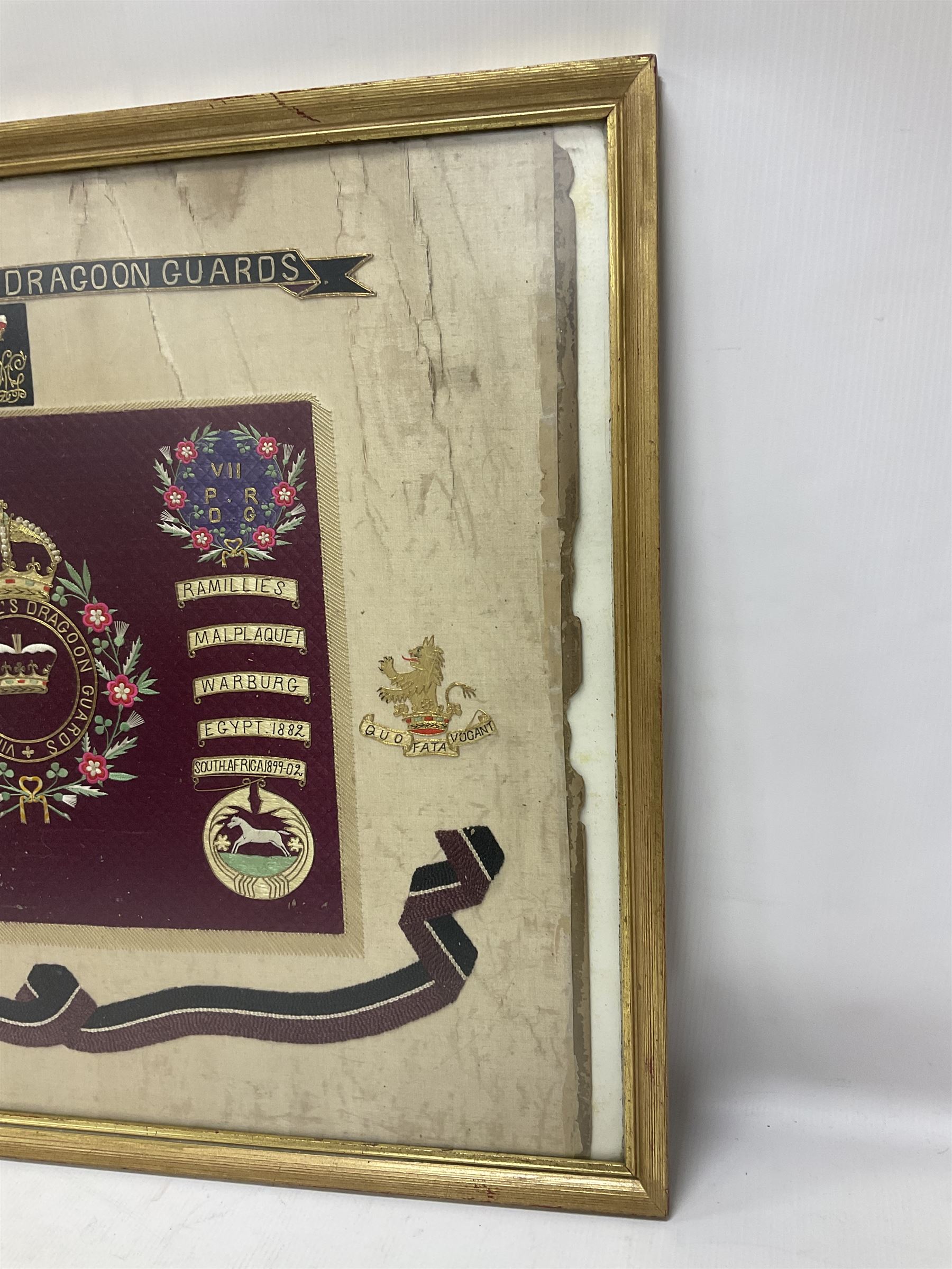 Commemorative Military needlework, headed 'VII Princess Royal's Dragoons Guard, the central flag has the regimental title, surrounded by a Union wreath of roses, thistles and shamrocks, topped with a crown, the Hanoverian white horse features in two corners, framed H58cm, L73cm