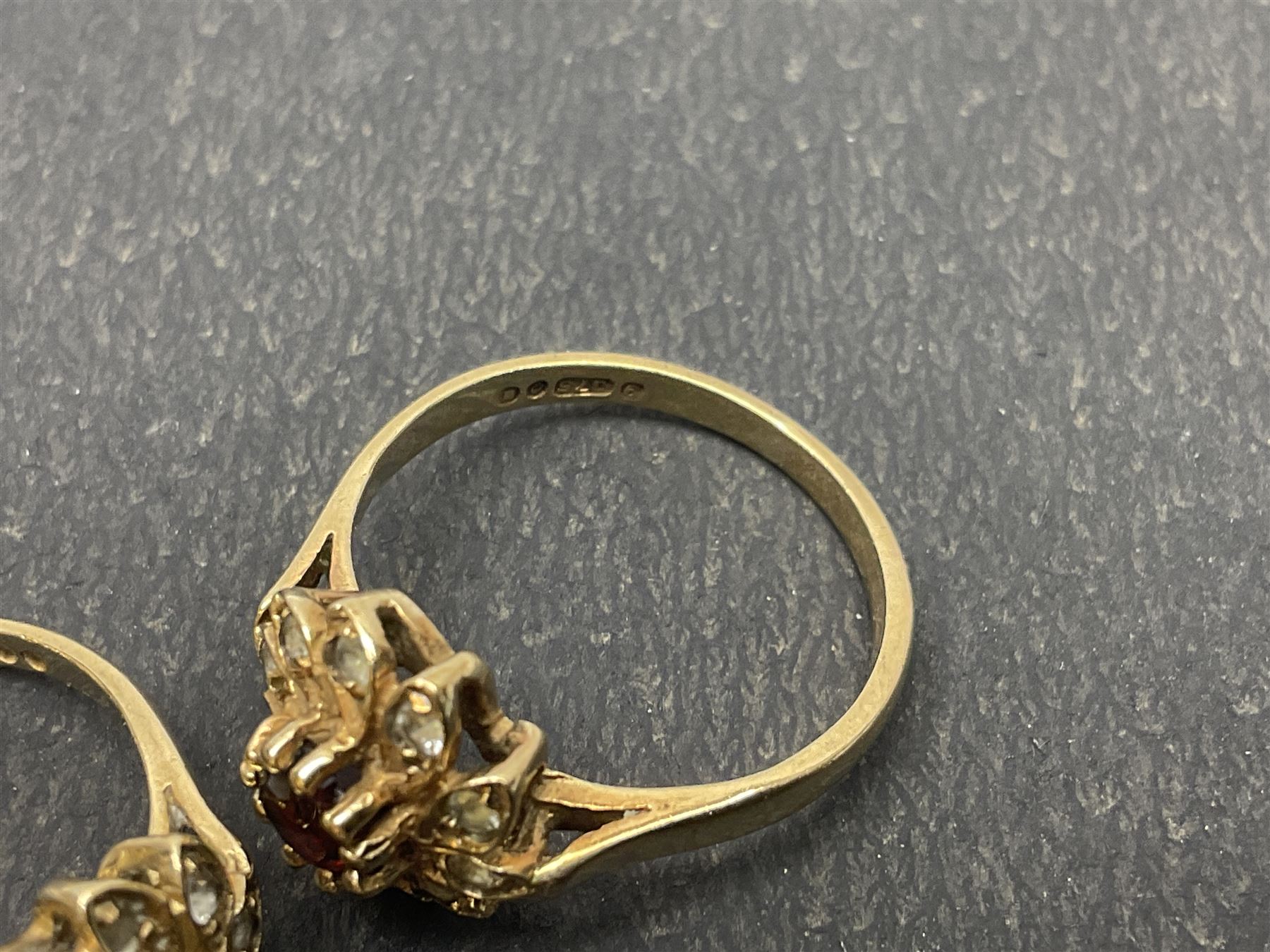 Two 9ct gold garnet and paste stone set cluster rings and a Early 20th century gold brooch, stamped 9ct