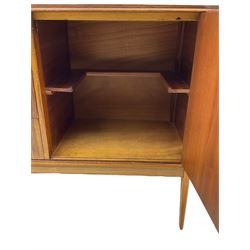 Mid 20th century teak sideboard, rectangular top with rounded corners over three central drawers, flanked by two cupboard doors enclosing shelves, raised on tapered supports