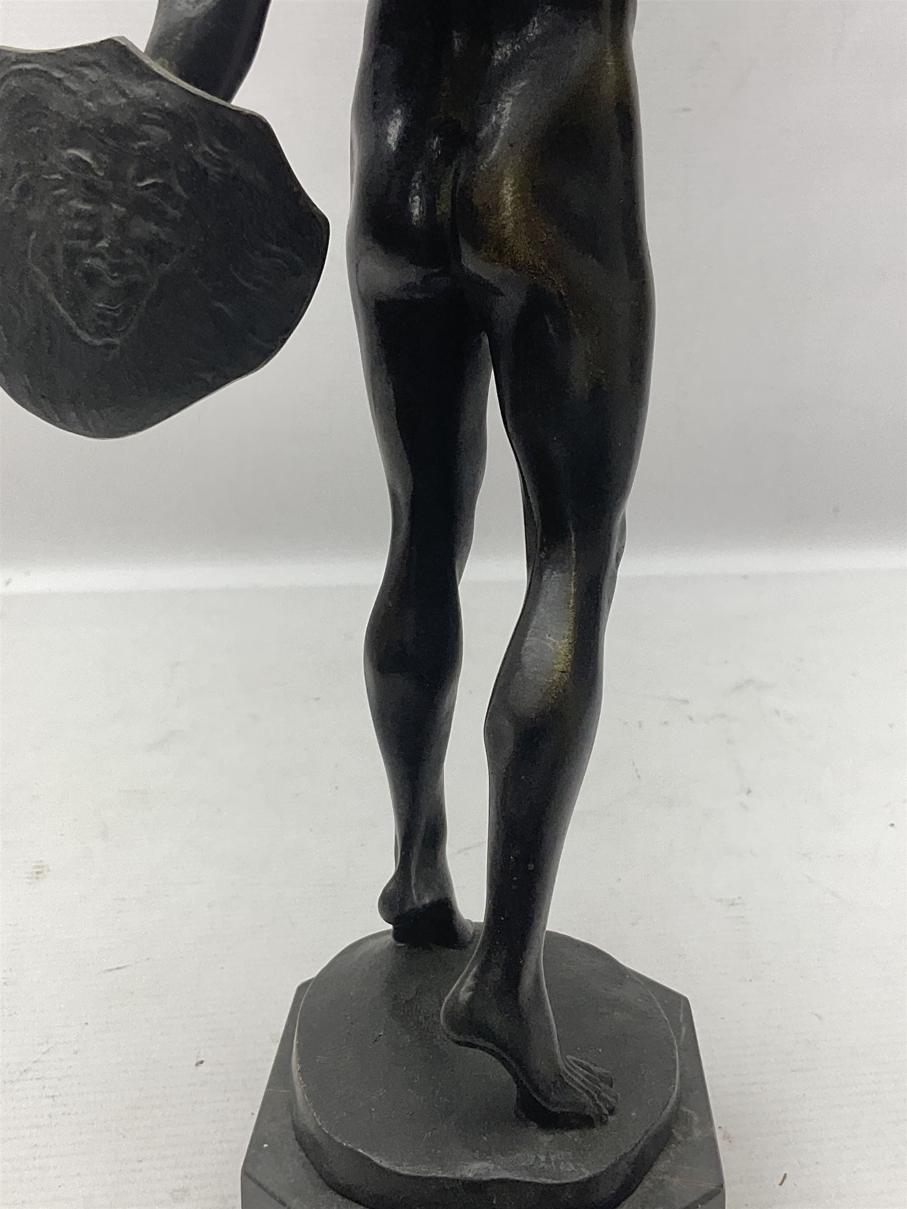 After Franz Iffland, bronzed figure, modelled as a man with fist raised holding a shield, signed to base, upon an octagonal base, H37cm