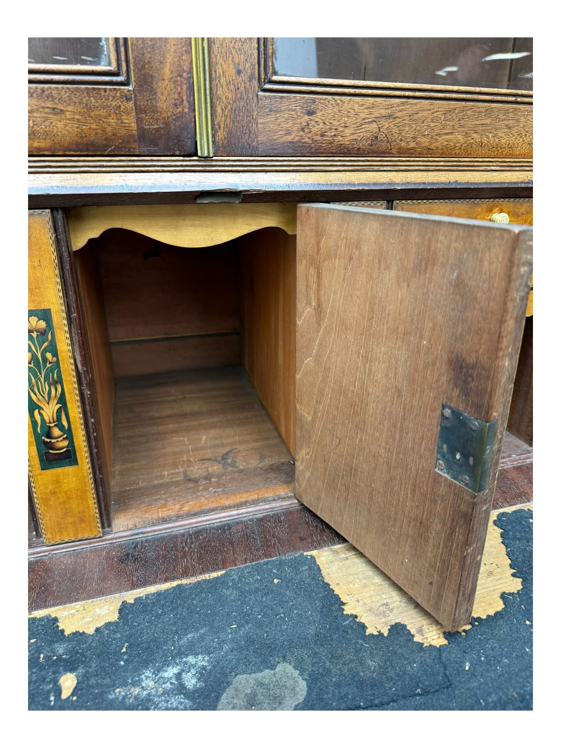 Early 19th century mahogany bureau bookcase, the projecting cornice over two Gothic-style astragal glazed doors enclosing two adjustable shelves, sloped hinged lid enclosing fitted interior and felt inset, four graduating drawers, on bracket feet