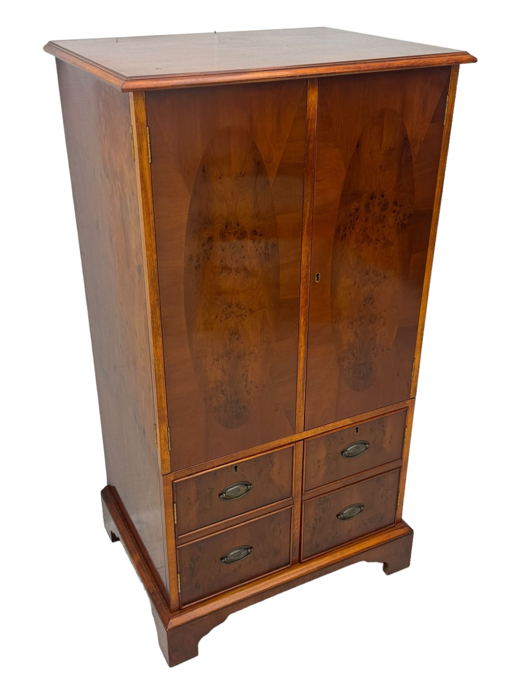 Wade - yew wood hi-fi cabinet, moulded rectangular hinged top over double-door cupboard with figured veneer, enclosing three adjustable shelves, lower section fitted with two cupboards to resemble four drawers, enclosing three drawers and open storage