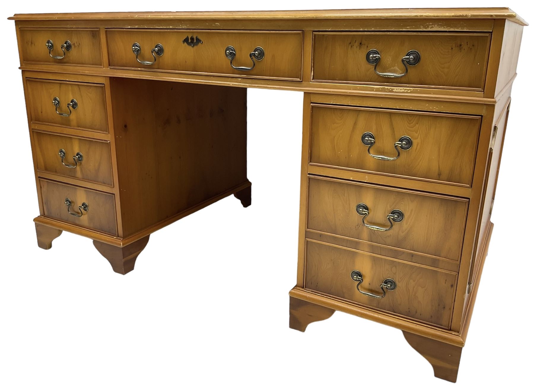 Georgian design yew wood twin pedestal desk, moulded rectangular top over nine cock-beaded drawers, on bracket feet