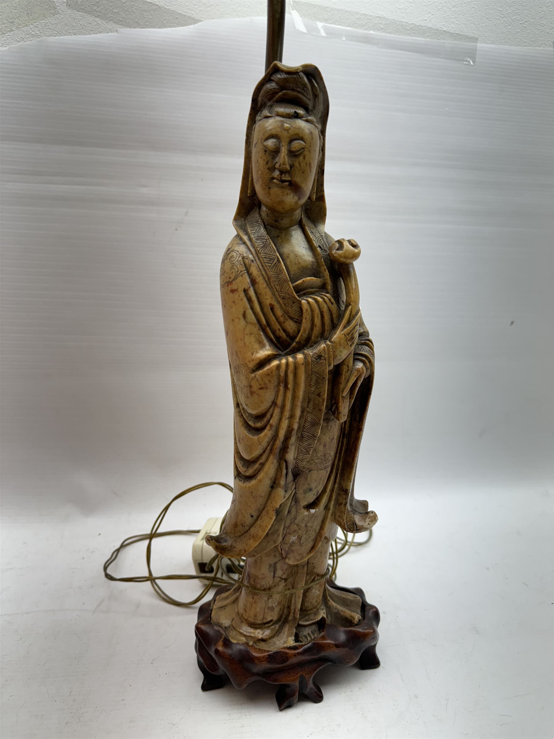 Carved soapstone lamp modelled as Guan Yin, upon hardwood base, with pink fabric shade, including shade H77.5cm