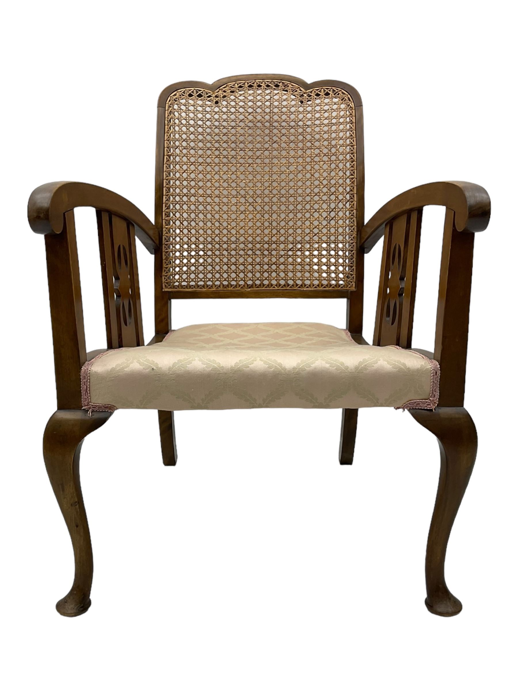 Early 20th century beech framed chair, with scalloped caned backrest, curved arms with pierced splats, upholstered seat in light pink fabric with gold trim, on cabriole supports