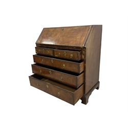 18th century walnut bureau, crossbanded and feather-banded rectangular top and fall-front, enclosing fitted interior with pigeonholes and correspondence drawers with bone handles, over two short and three long graduating drawers with moulded facias and original brass handles, on bracket feet