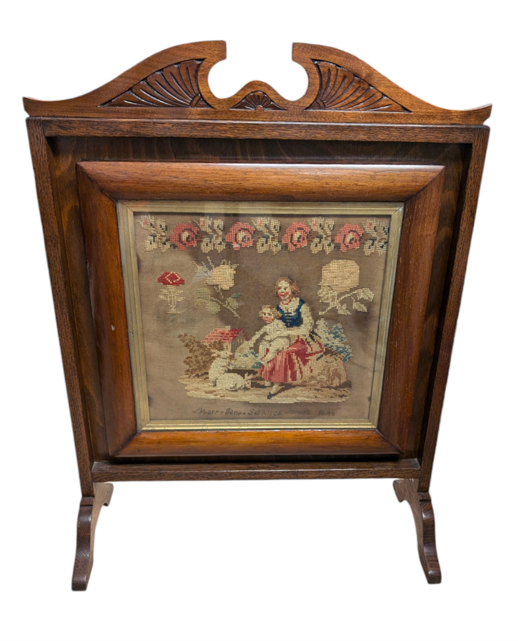 Victorian sampler, depicting woman and young child feeding rabbits, worked by Mary Ann Siswick 1849, set within an oak fire screen, fire screen H75.5cm