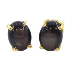 Pair of gold black / brown star sapphire stud earrings