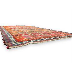 Southwest Persian Qashqai Kilim ground rug, featuring a series of horizontal striped panels each filled with intricate geometric designs, enclosed by a dark blue and ivory border with stylised star and zigzag motifs