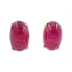 Pair of 9ct gold oval cut cabochon ruby stud earrings, stamped