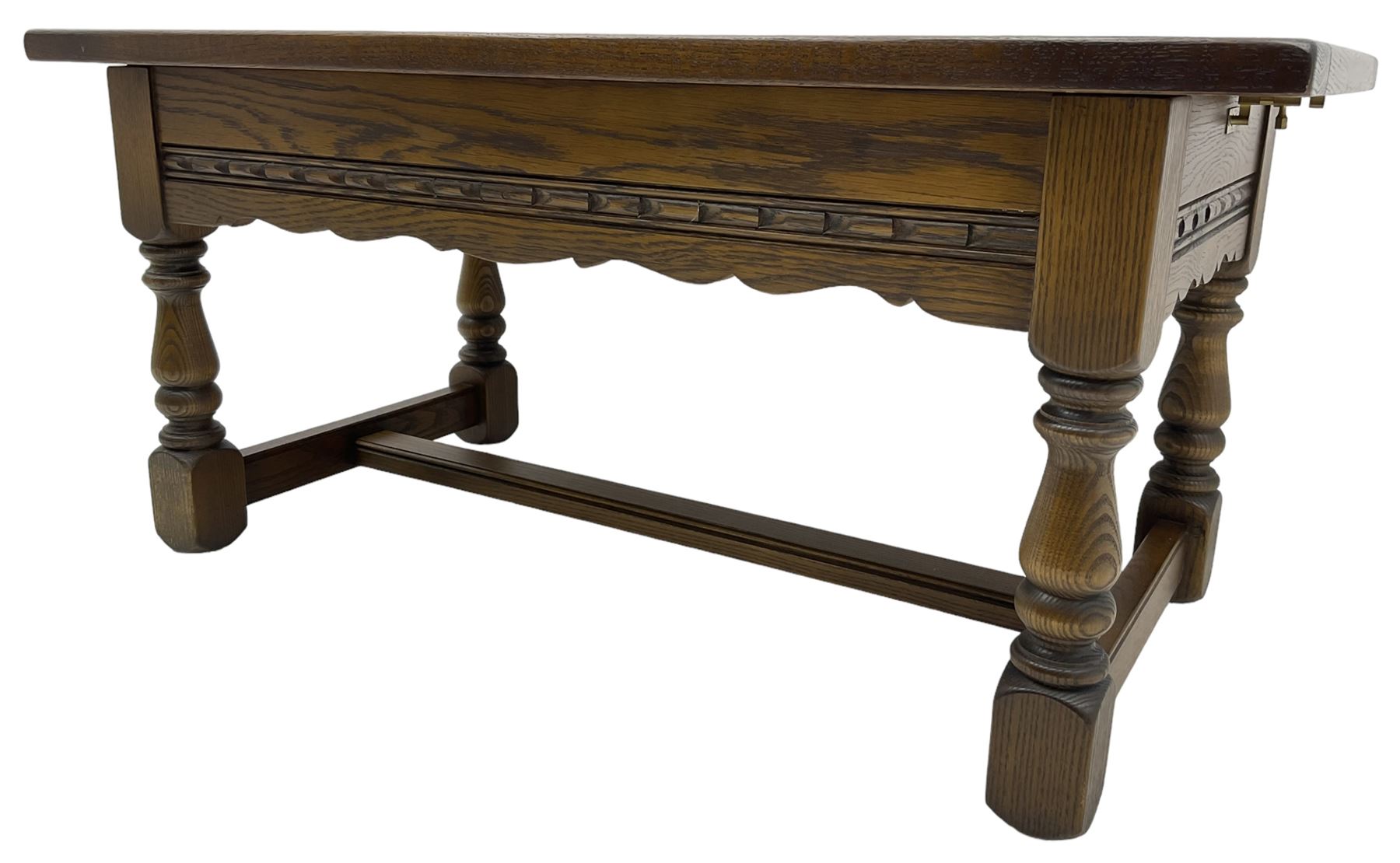 Old Charm - oak coffee table, rectangular top with glass inset over carved scalloped apron, on turned square supports connected by H-stretcher