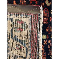 South West Persian Abadeh crimson ground rug, indigo ground with crimson lozenge field, decorated all over with small stylised motifs of flowerheads, hooks, animals and birds, guarded border decorated with trailing leaves and stylised plant motifs 