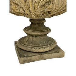 Pair of composite stone garden urn planters, acanthus leaf garland rim over foliate decorated body, stepped foot on square base