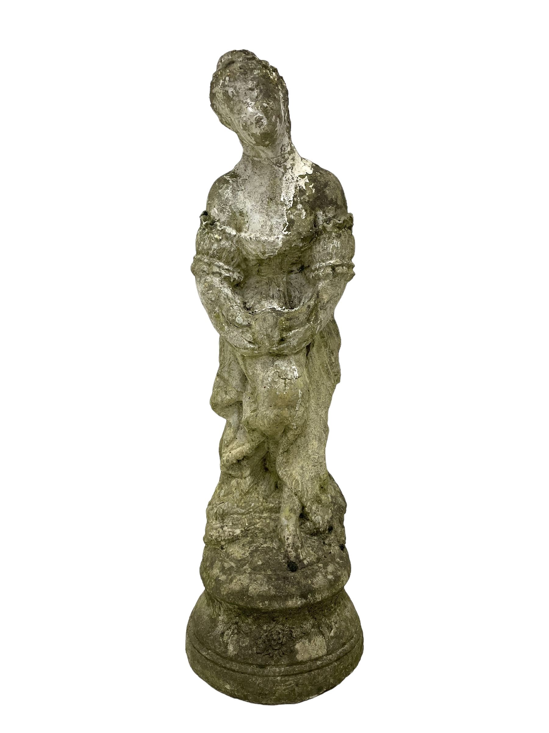 Weathered and painted cast stone garden statue, in the form of an Italian maiden with an ornate tied hairstyle and flowing gown, holding a wounded dove, on a turned base with garland decoration