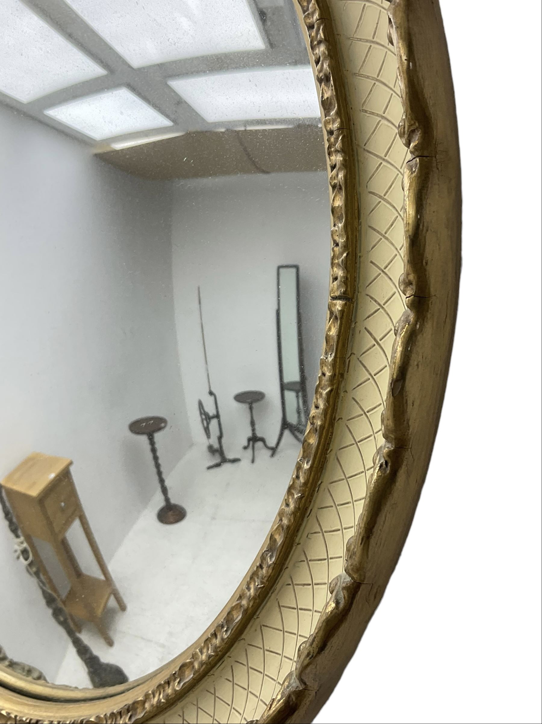 Convex wall mirror in cream and gilt finish frame