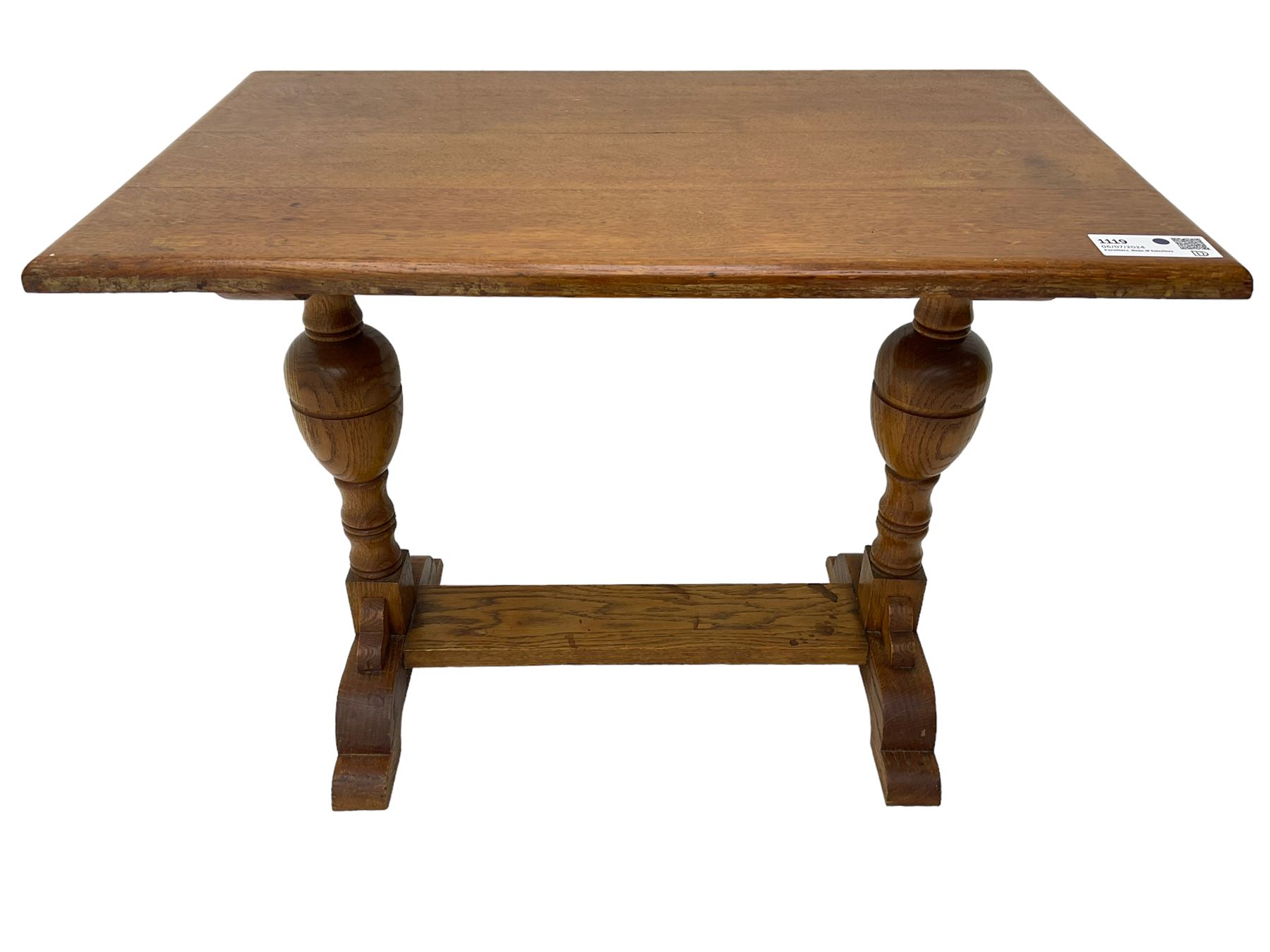 20th century oak occasional table, rectangular top on turned twin pillar supports, carved with squirrel motif, on shaped sledge feet united by stretcher 