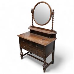 Art Nouveau oak dressing table, raised circular bevelled mirror on spiral turned supports, fitted with two drawers with scrolling foliate carvings, on turned supports joined by stretchers