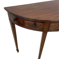 19th century mahogany demi-lune side or console table, reeded edge over central frieze drawer flanked by two hinged drawers with cock-beaded facias and turned handles, raised on square tapering supports with spade feet, the rear supports and feet chamfered in profile